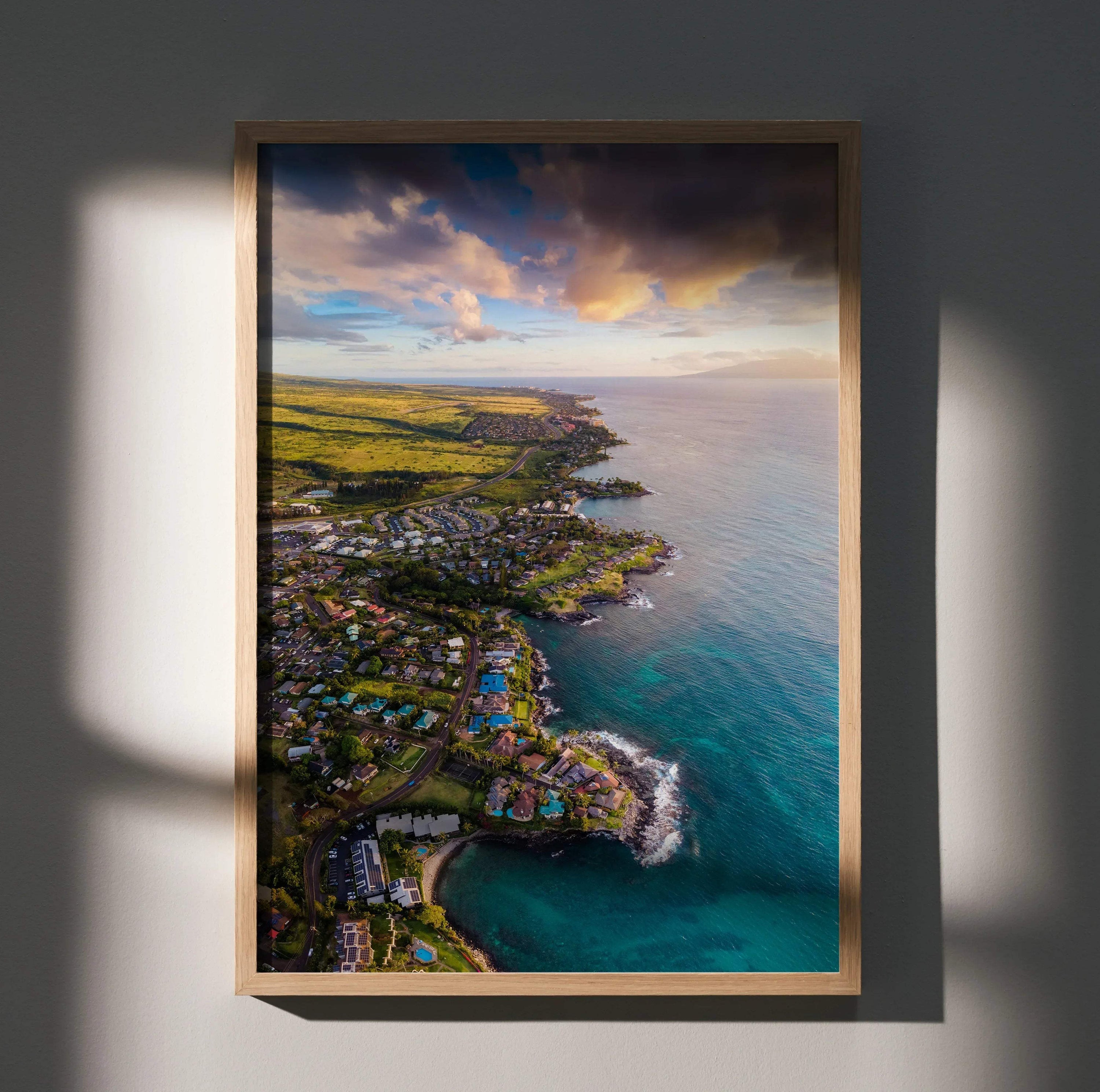 Vertical wall art poster of a serene ocean sunset over a coastal town with vibrant sky colors.