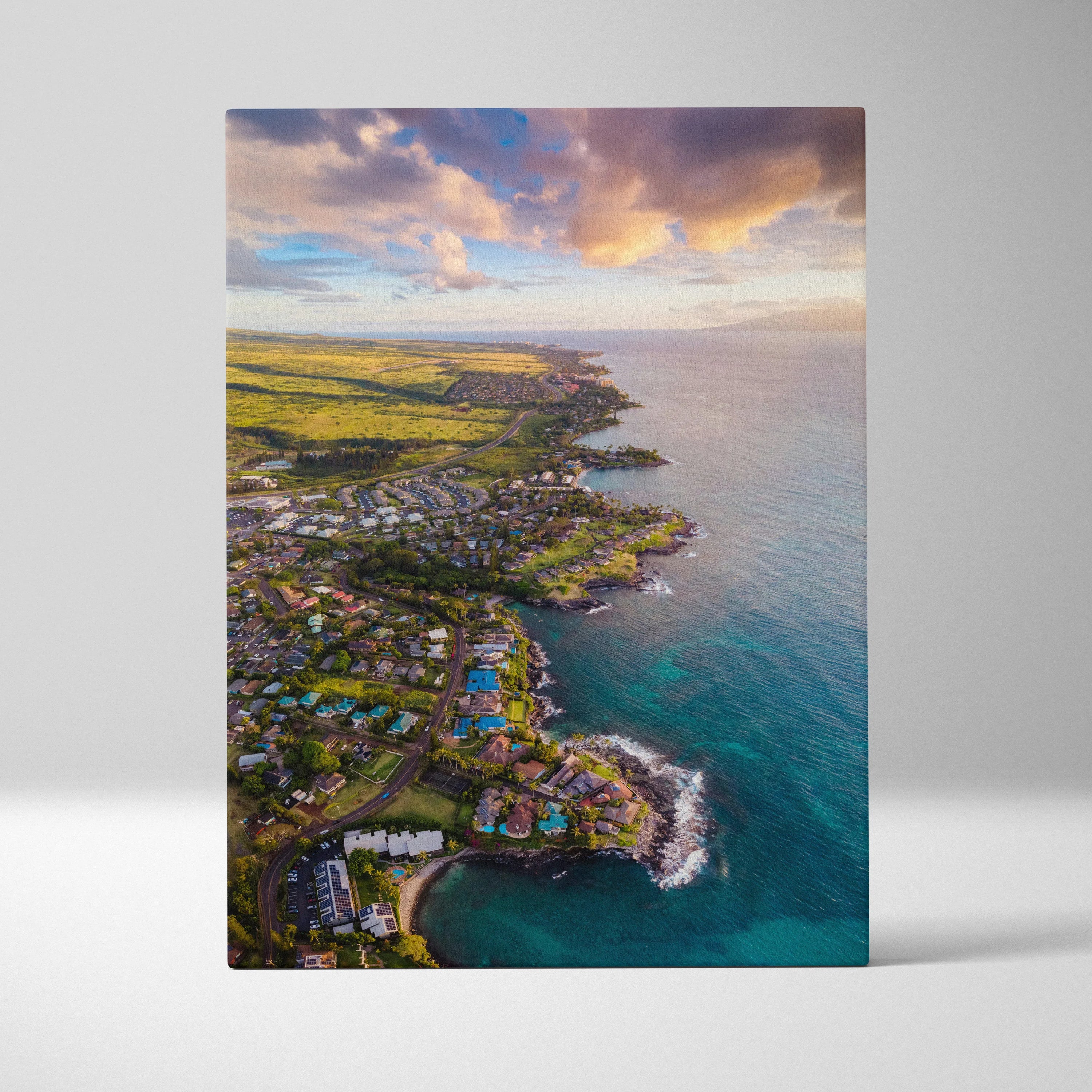 Vertical canvas wall art featuring a vibrant sunset over a coastal city skyline with beach and buildings.