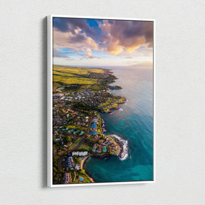 Vertical canvas wall art of a vibrant sunset over a coastal city skyline with beach and buildings.