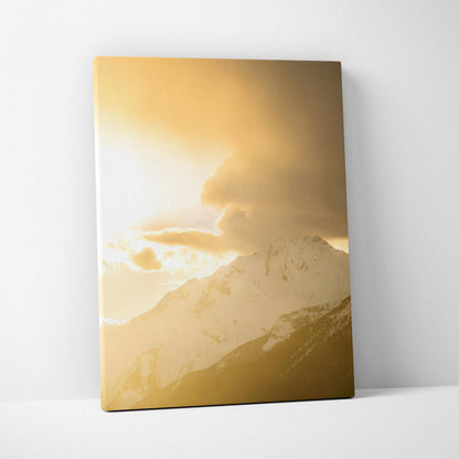 Canvas wall art featuring a golden mountain sunset with dramatic clouds and snowy peaks.