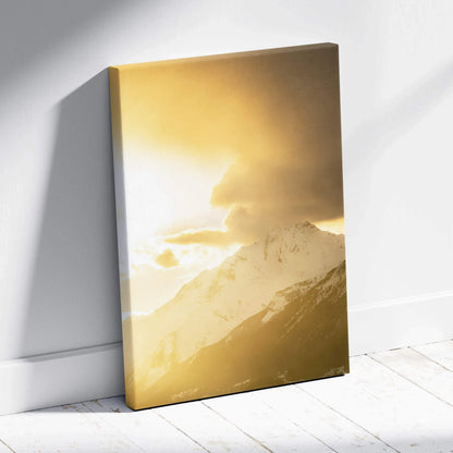 Canvas wall art featuring a golden sunset over snow-capped mountain peaks.