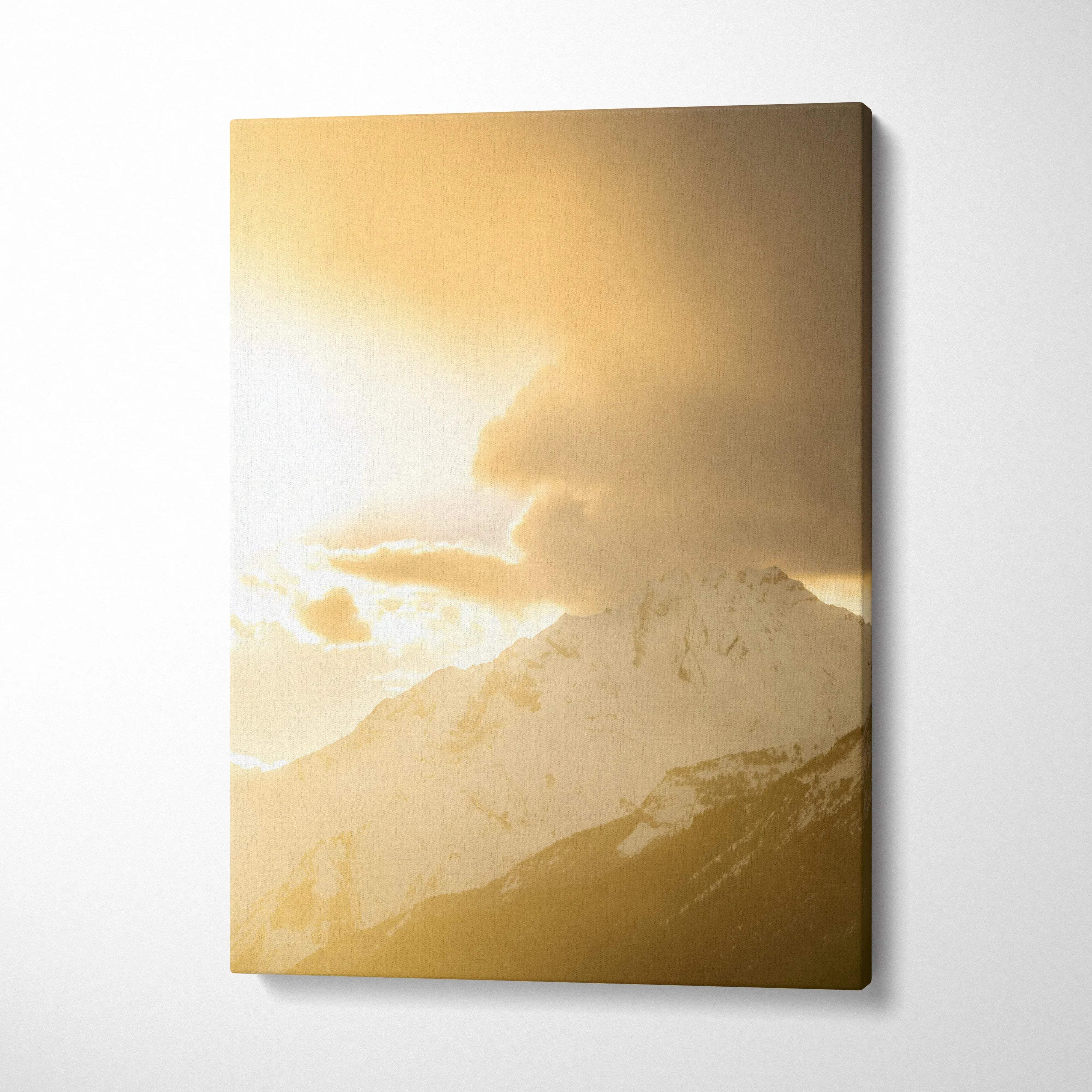 Canvas wall art featuring a golden sunset over snow-capped mountain peaks with soft clouds.