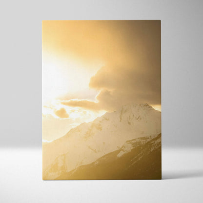 Canvas wall art featuring a golden mountain sunset with dramatic clouds over snow-capped peaks.