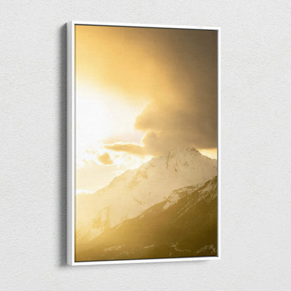 Vertical canvas wall art featuring a golden sunset over snow-capped mountains.