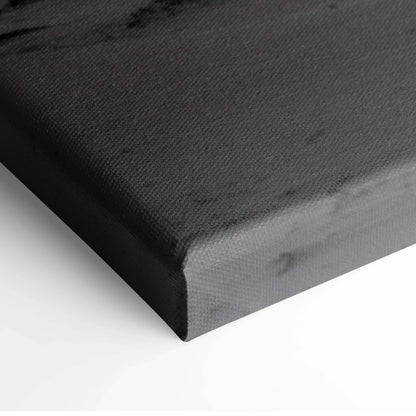 Black edge close-up of canvas wall art with textured surface and wrapped corners.