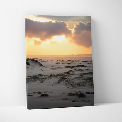Snowy landscape with glowing sunset sky on vertical canvas wall art.