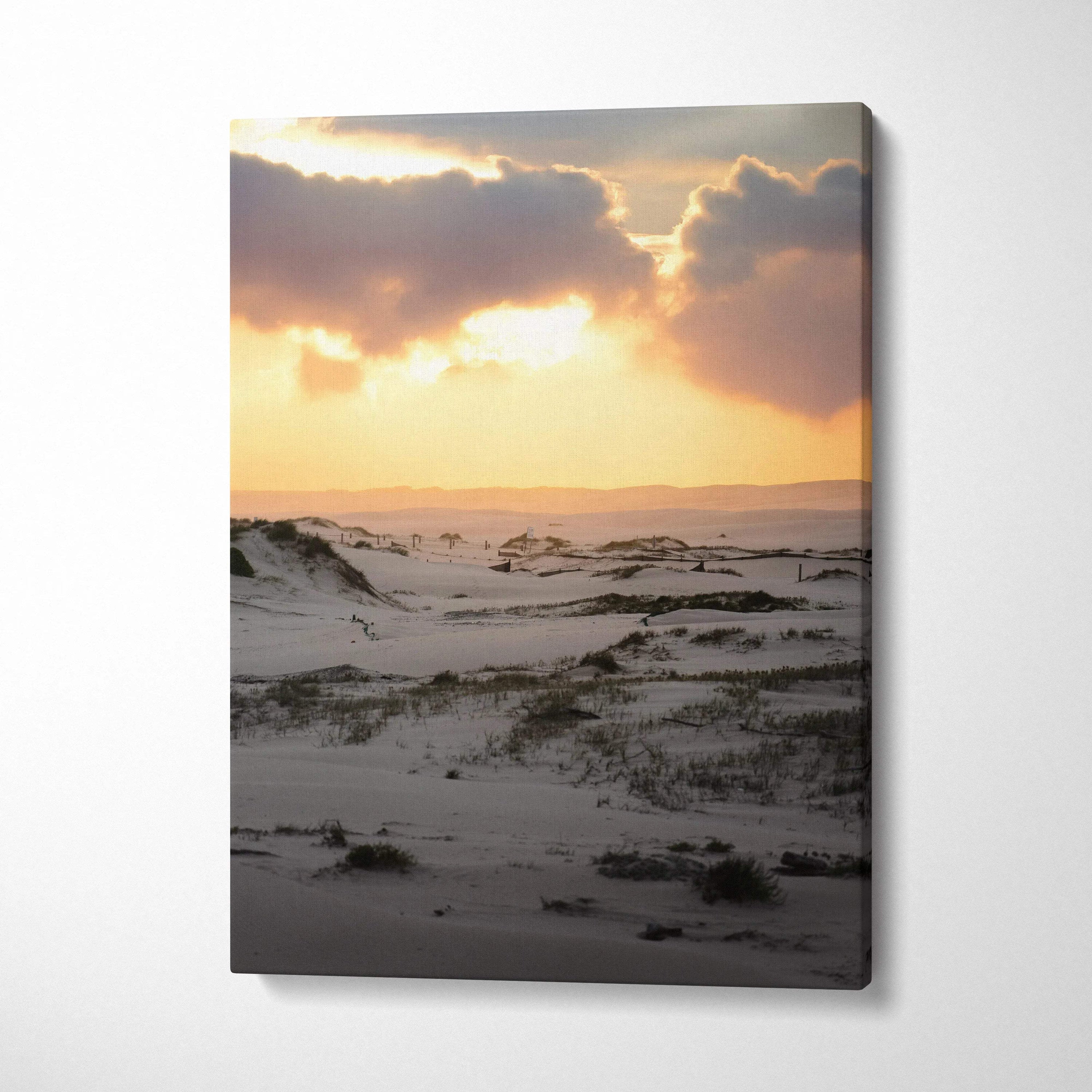 Snowy dunes under a golden sunset sky canvas wall art with warm light and soft clouds.