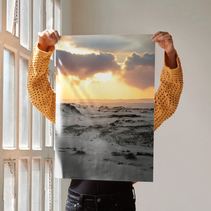 Snow-covered landscape with golden sunset rays breaking through clouds, vertical poster wall art.