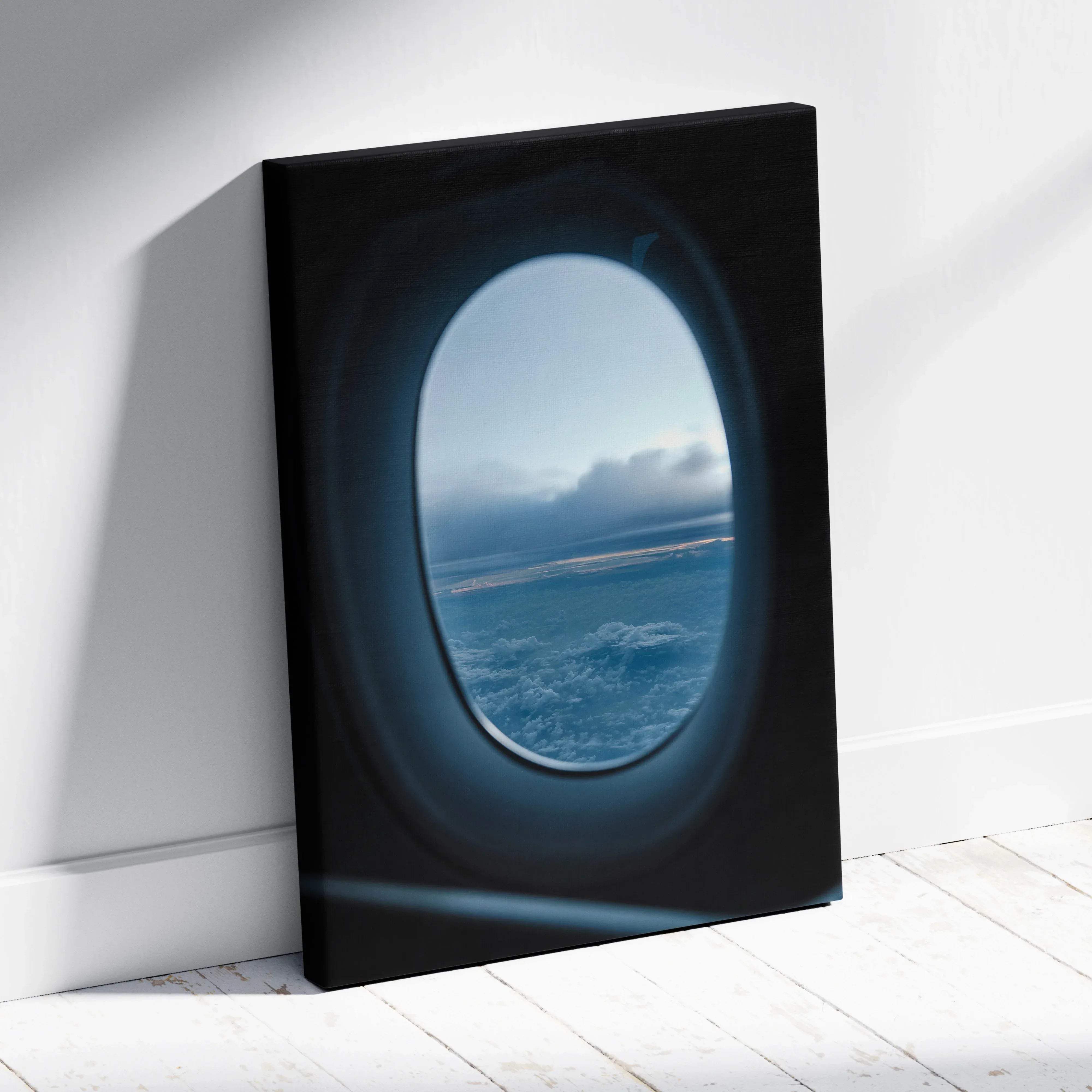 Black canvas print featuring a circular airplane window view of calm blue clouds and ocean aerial landscape