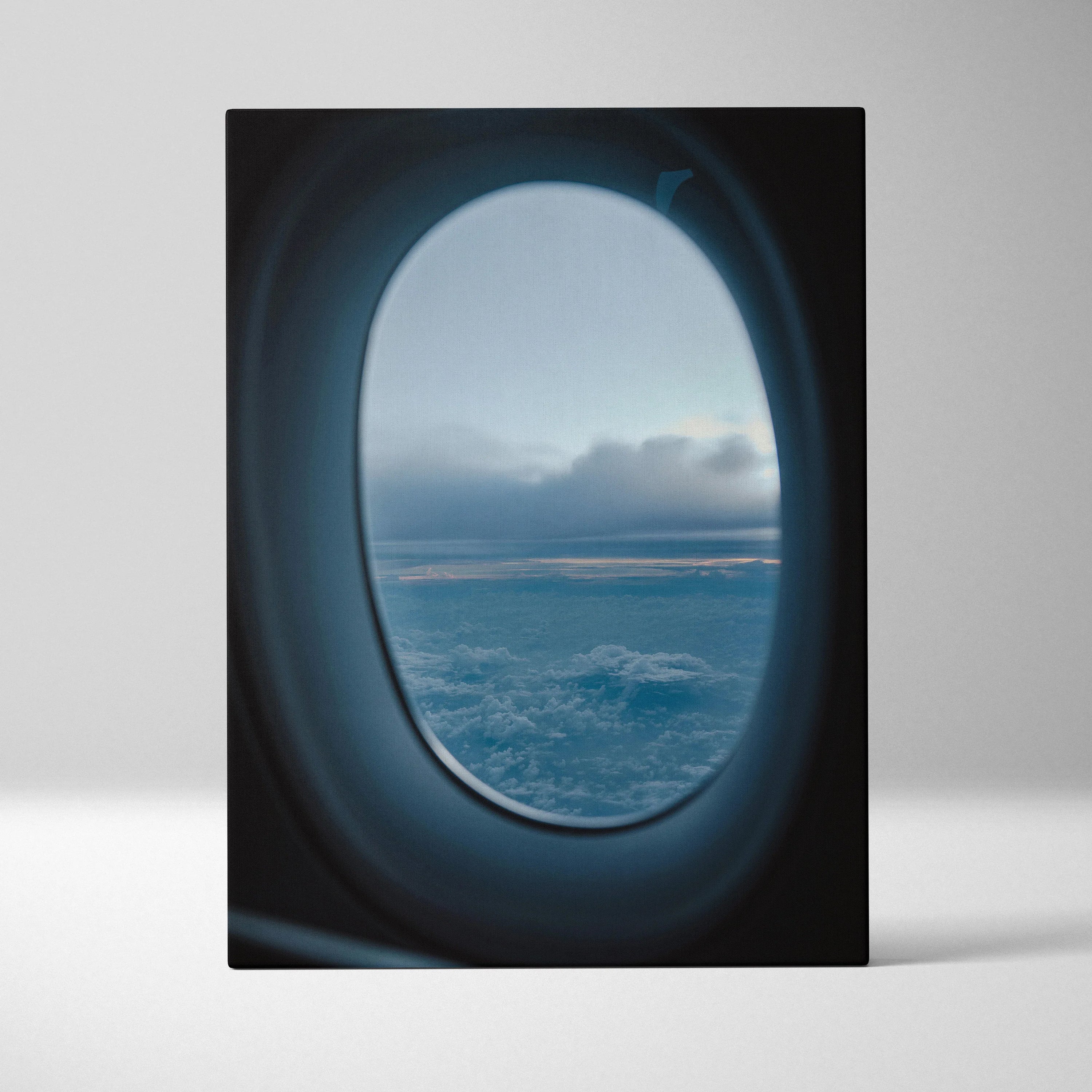 Vertical canvas wall art showing airplane window view of clouds and sky at sunset.