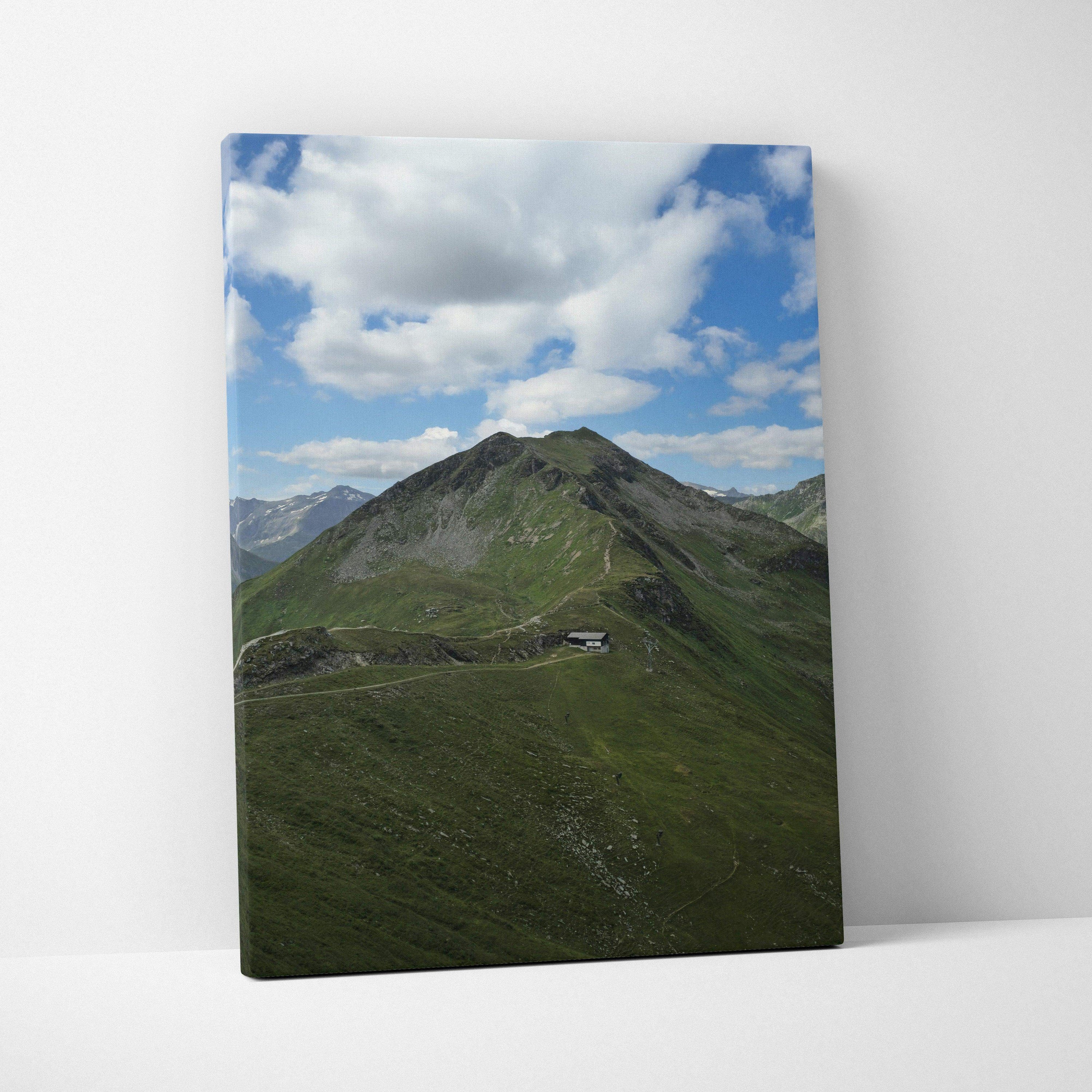 Mountain landscape with green slopes and blue sky on vertical canvas wall art.