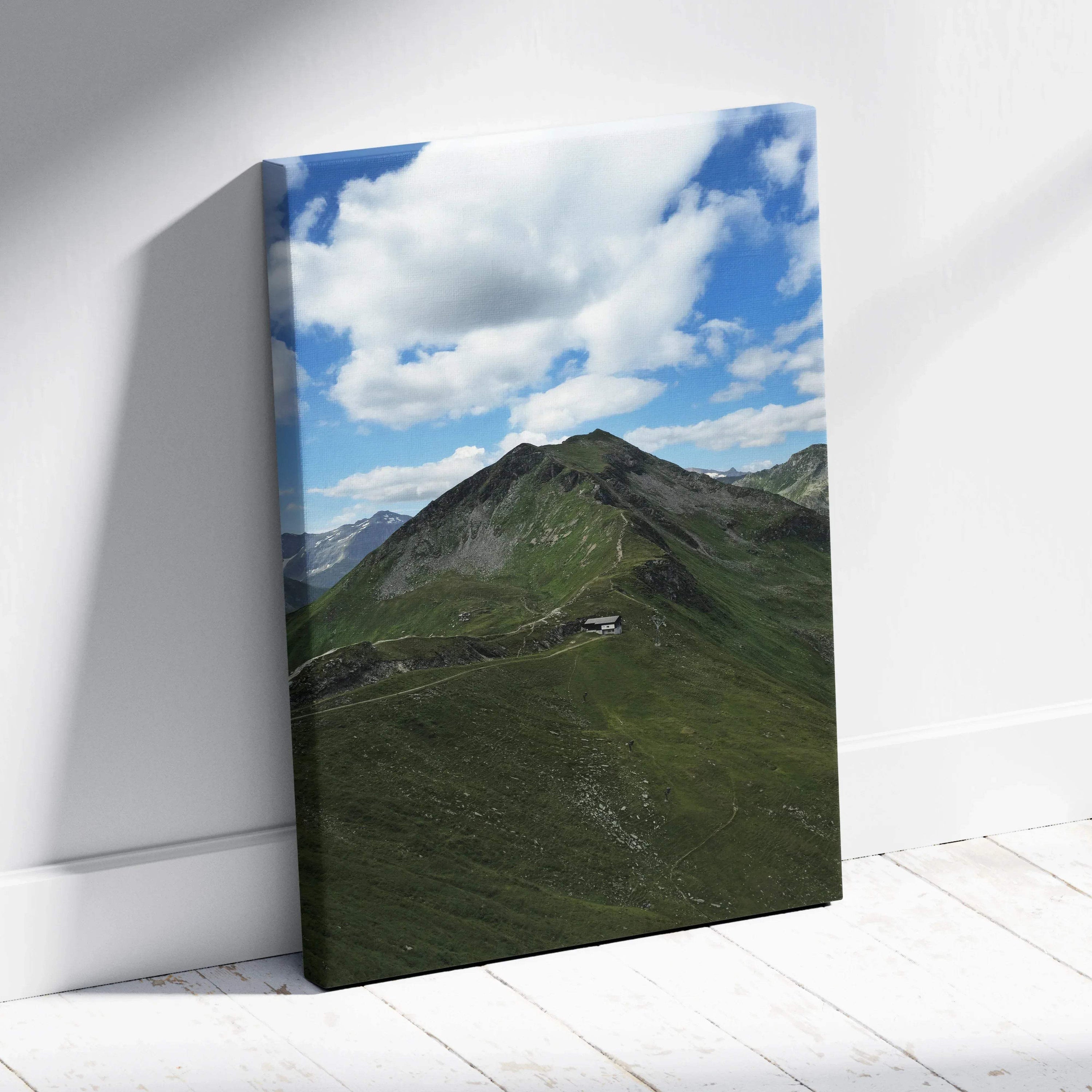 Vertical canvas wall art featuring lush green mountain peaks under a bright blue sky with scattered clouds.