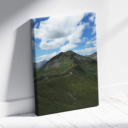 Vertical canvas wall art featuring lush green mountain peaks under a bright blue sky with scattered clouds.