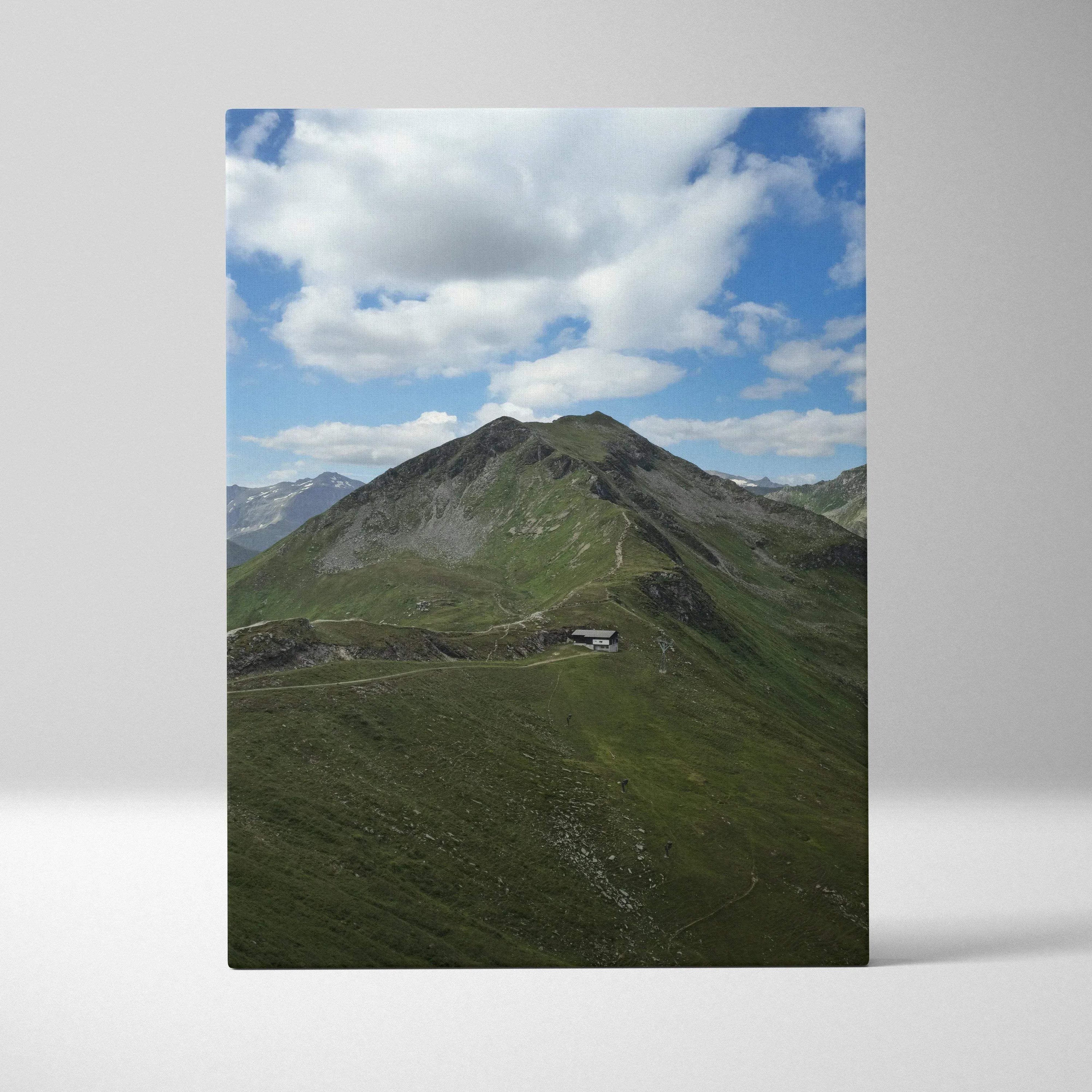 Vertical canvas wall art featuring a green mountain landscape under a cloudy blue sky.