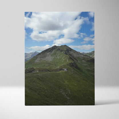 Vertical canvas wall art featuring a green mountain landscape under a cloudy blue sky.