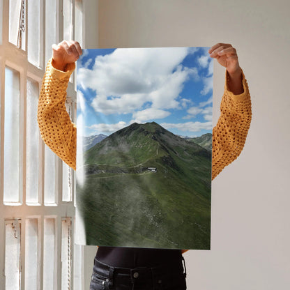 Vertical mountain landscape poster with lush green slopes and a partly cloudy blue sky wall art print.