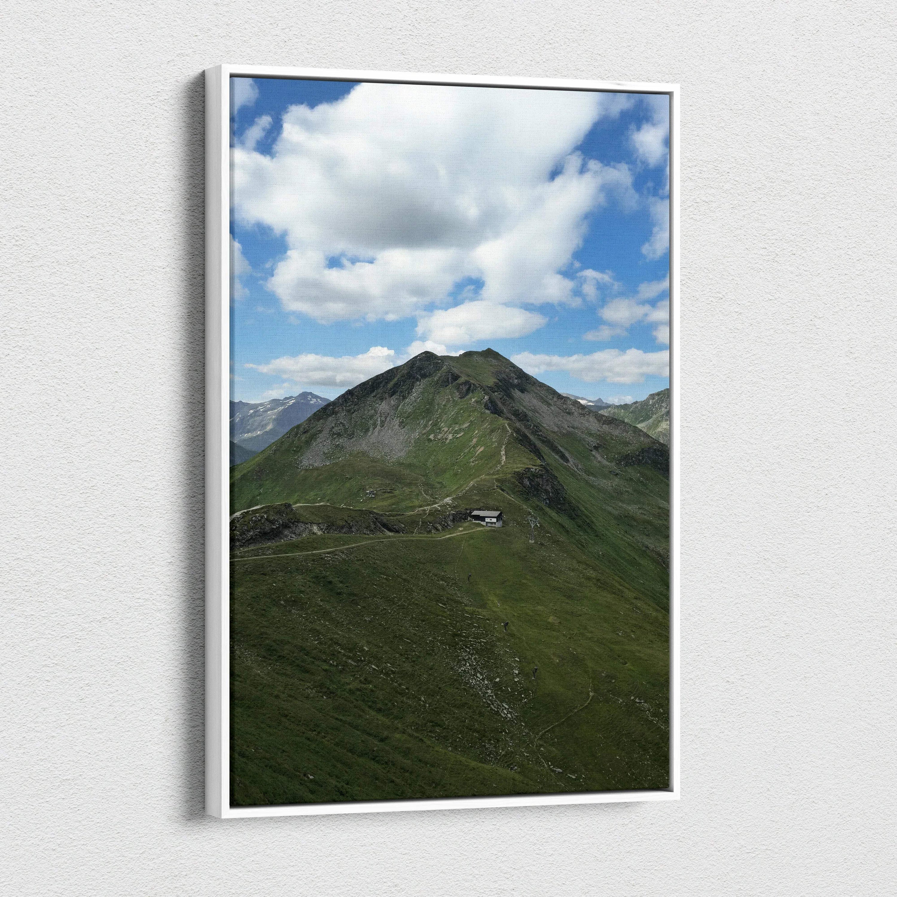 Vertical canvas wall art featuring a green mountain peak under a blue sky with white clouds.