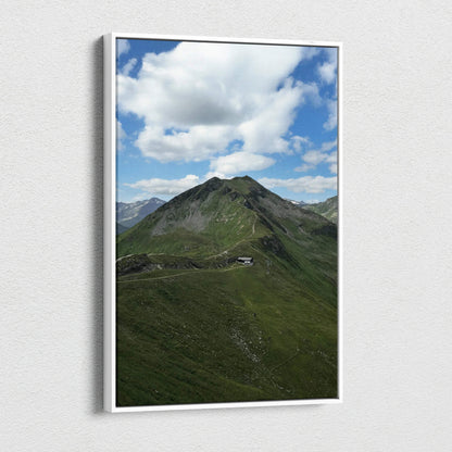 Vertical canvas wall art featuring a green mountain peak under a blue sky with white clouds.