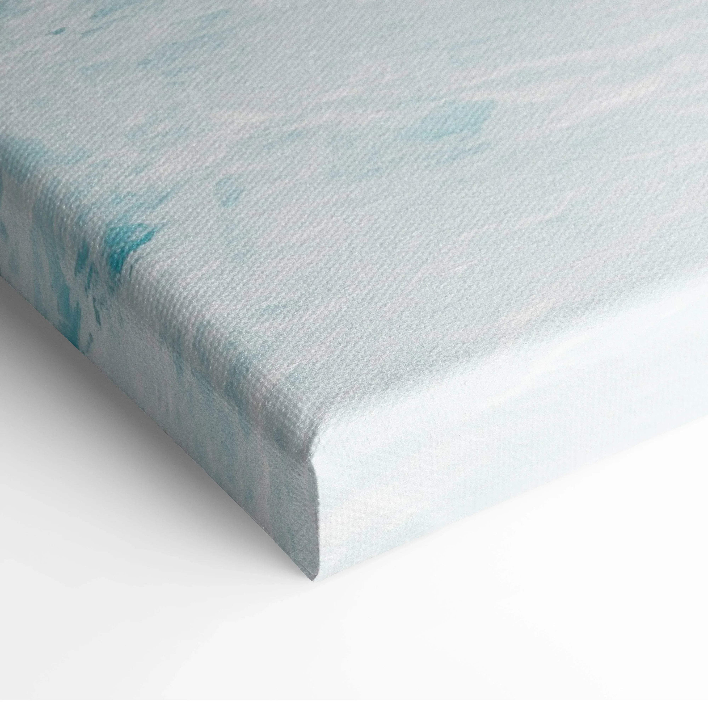 Close-up of canvas wall art edge with soft ocean blue and white sunset colors.