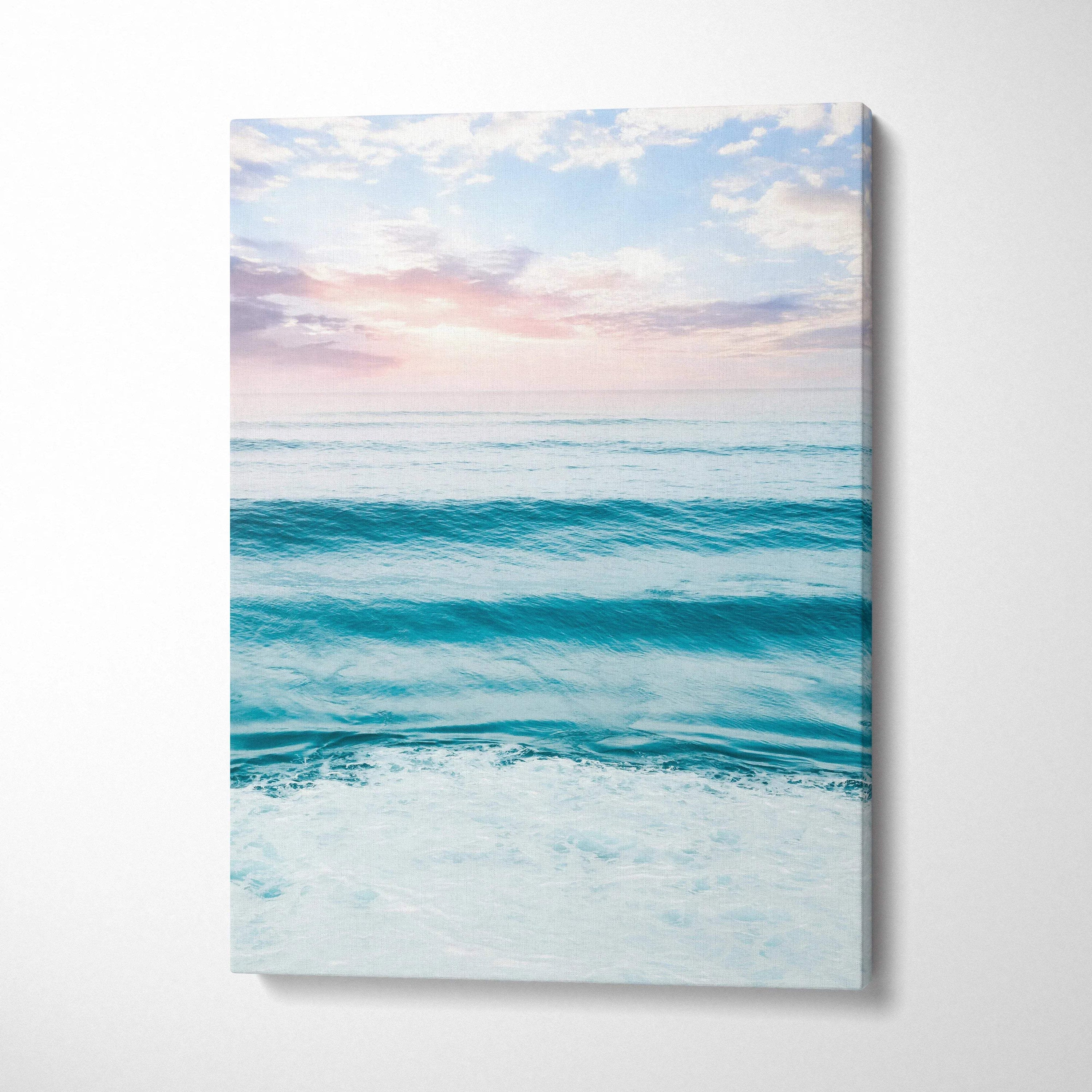 Vertical canvas wall art featuring a serene beach sunset over calm ocean waves.