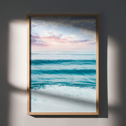 Ocean sunset poster with calm waves and soft pastel sky in vertical wall art frame.