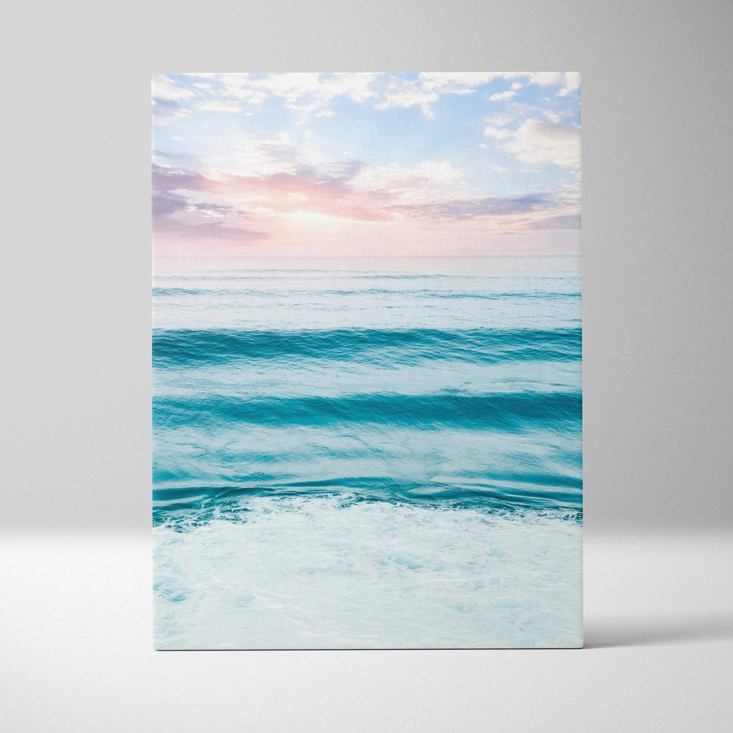 Vertical canvas wall art featuring a serene ocean sunset with soft pastel sky and gentle waves.