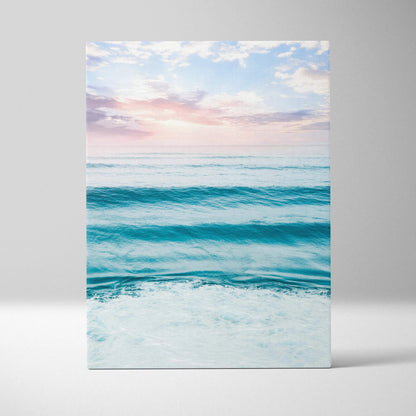 Vertical canvas wall art featuring a serene ocean sunset with soft pastel sky and gentle waves.