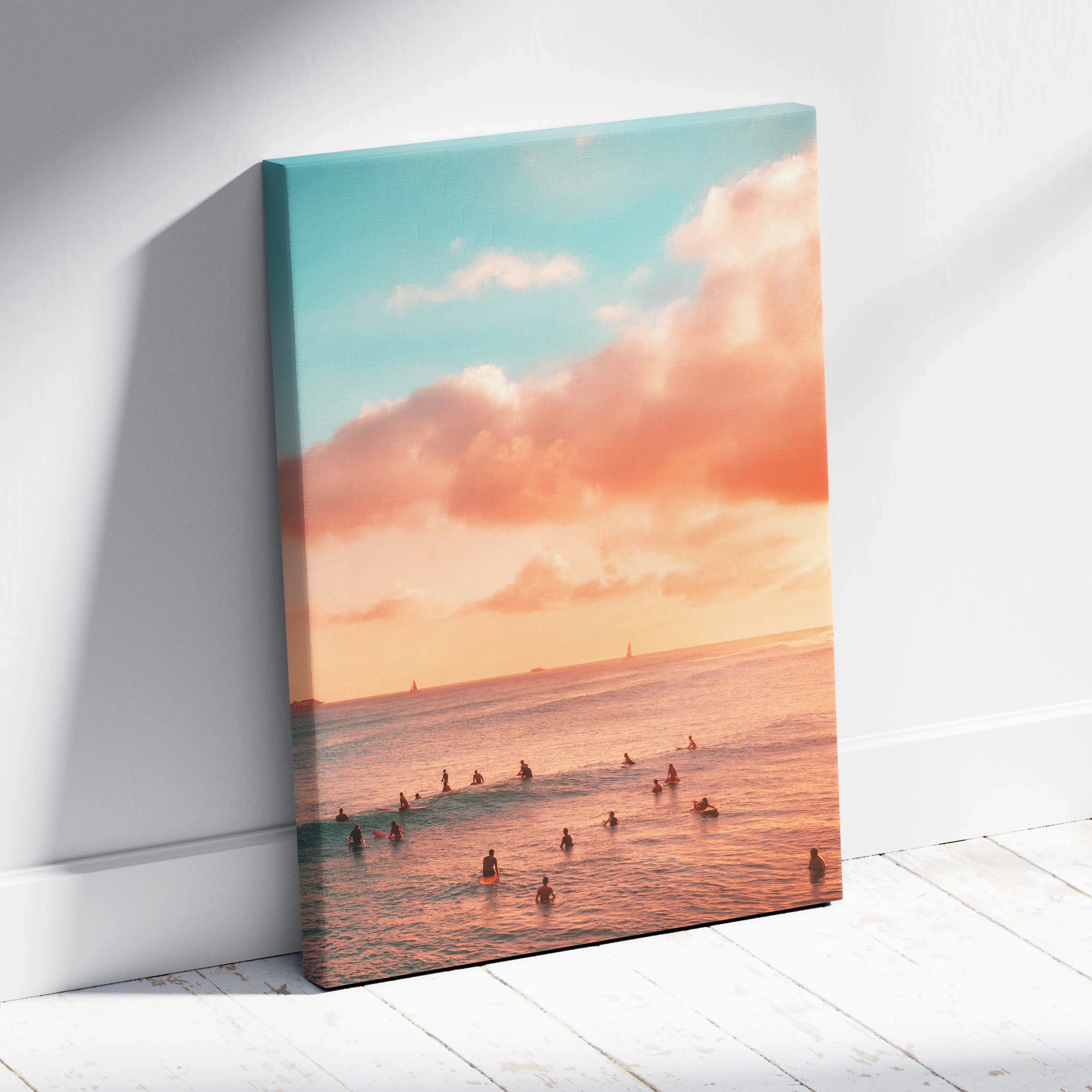 Golden sunset ocean beach scene on vertical canvas wall art with soft pastel sky and silhouetted swimmers.