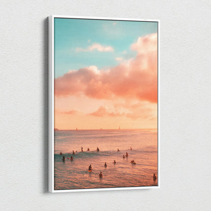 Vertical canvas wall art featuring a golden sunset over ocean with silhouetted swimmers and soft clouds.