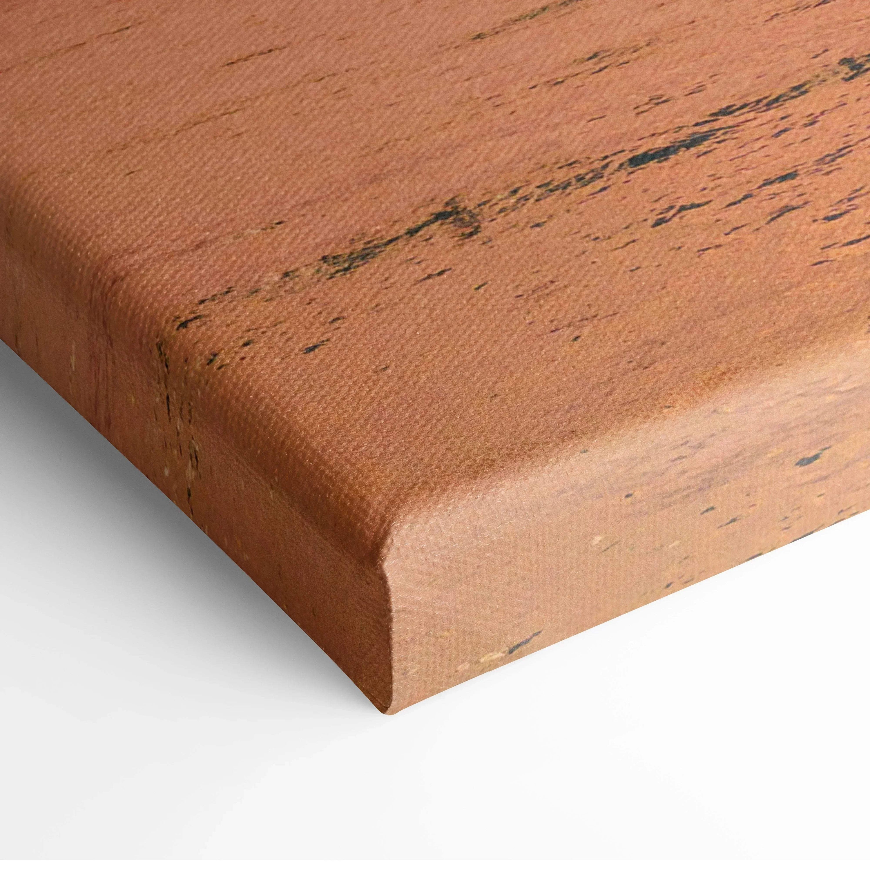 Close-up of textured canvas wall art with warm ocean sunset colors and subtle natural patterns.