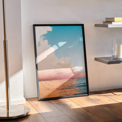 Ocean Sunset poster with vibrant orange and blue sky over calm ocean, vertical wall art in black frame.
