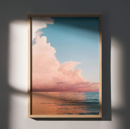 Ocean sunset poster with vibrant pink clouds over calm ocean water vertical wall art.