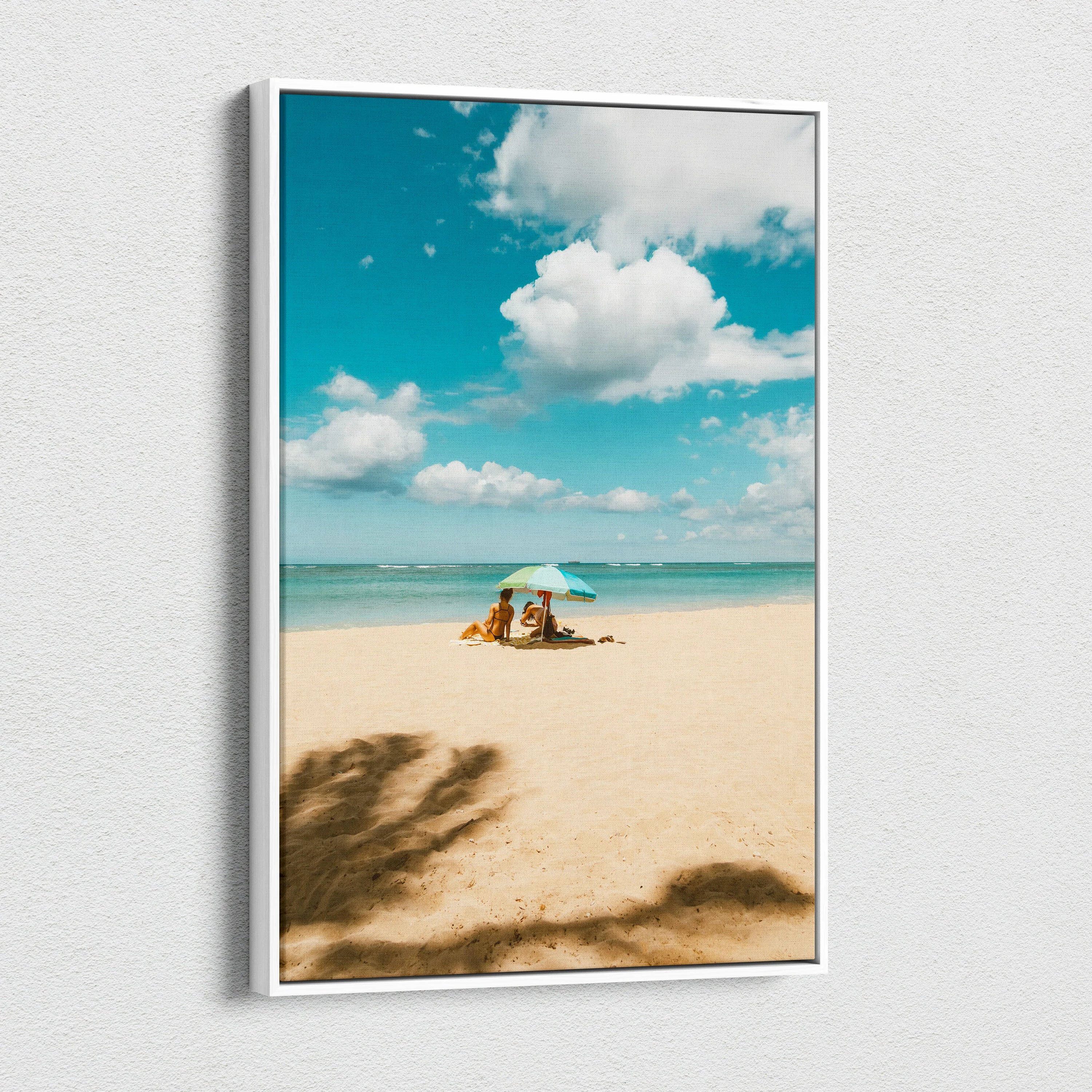Canvas wall art featuring a tranquil beach scene with clear blue sky and soft sand shadows.