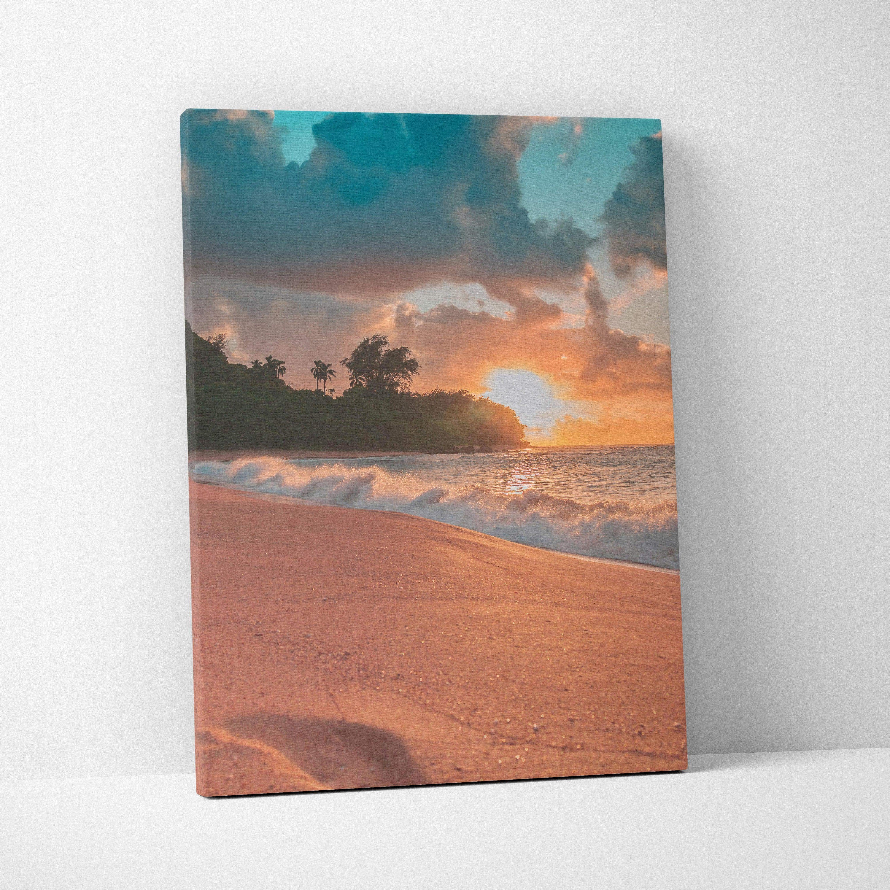 Vibrant beach sunset canvas wall art with orange sand, crashing waves, and silhouetted trees.