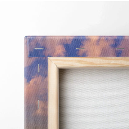 Close-up of wooden frame corner on canvas wall art with colorful sunset sky print.