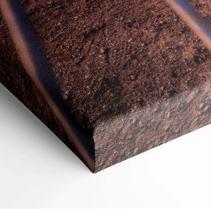 Close-up of textured canvas wall art corner with dark brown and black tones.