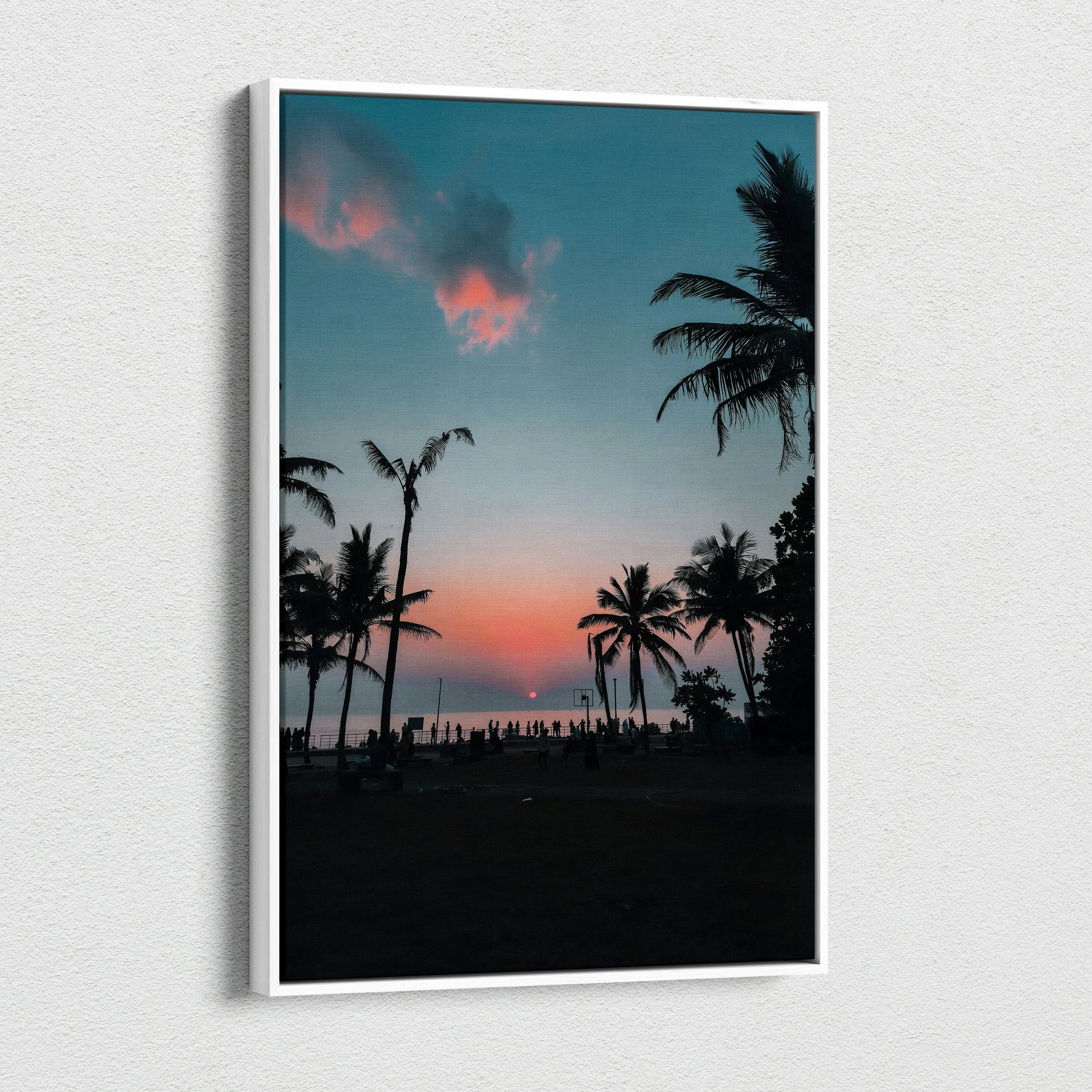 Vertical canvas wall art featuring a serene ocean sunset with silhouetted palm trees and vibrant sky colors.