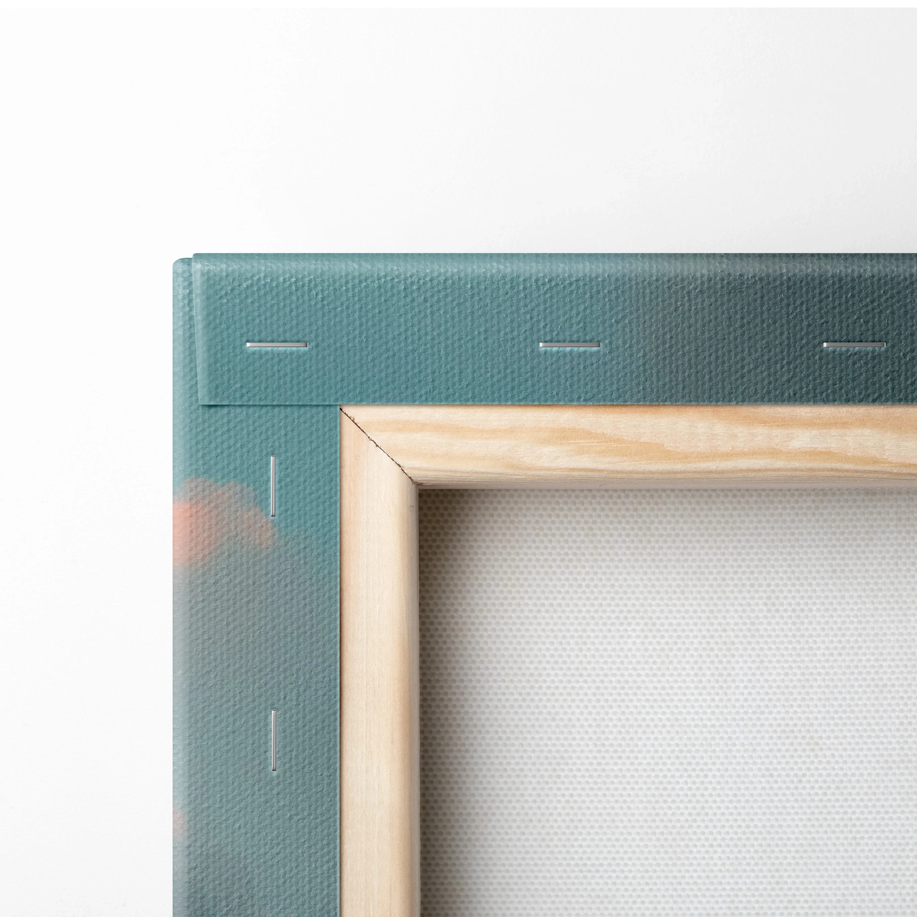 Close-up of wooden frame and stretched canvas corner showing teal canvas wall art backing and natural wood stretcher bars.