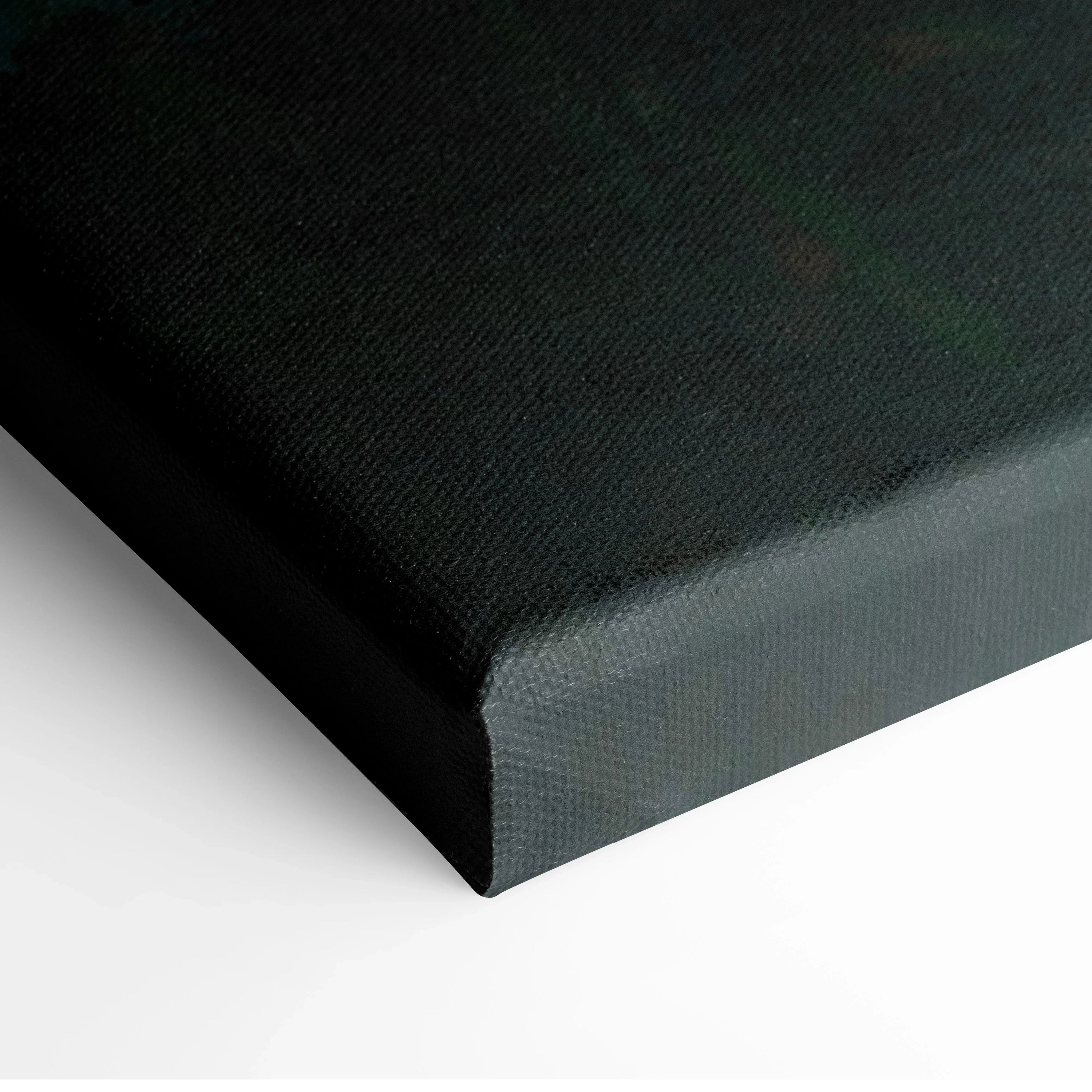 Close-up of black canvas wrap edge on vertical wall art panel.
