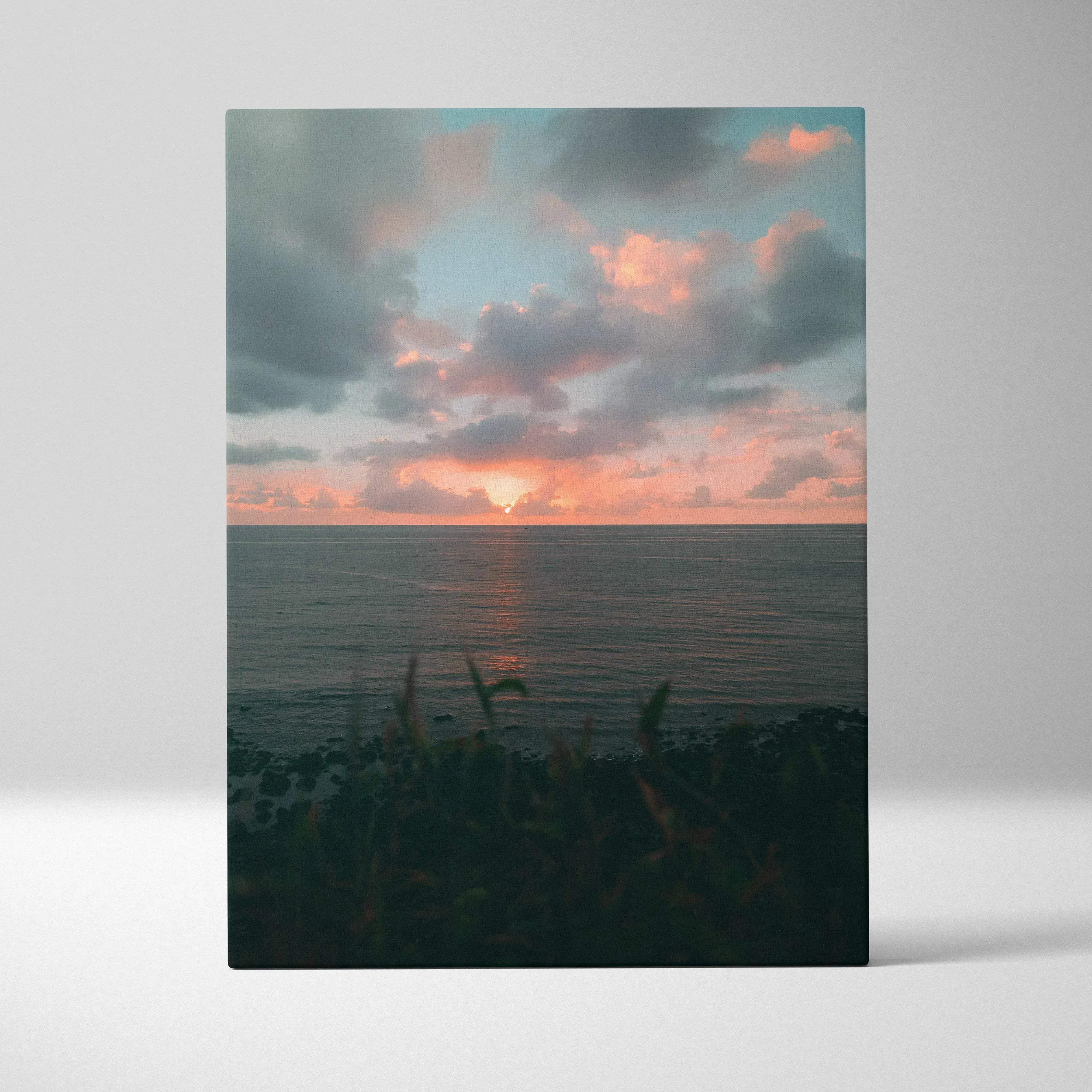 A rectangular canvas wall art featuring a serene beach sunset over ocean with warm pink and orange coastal tones