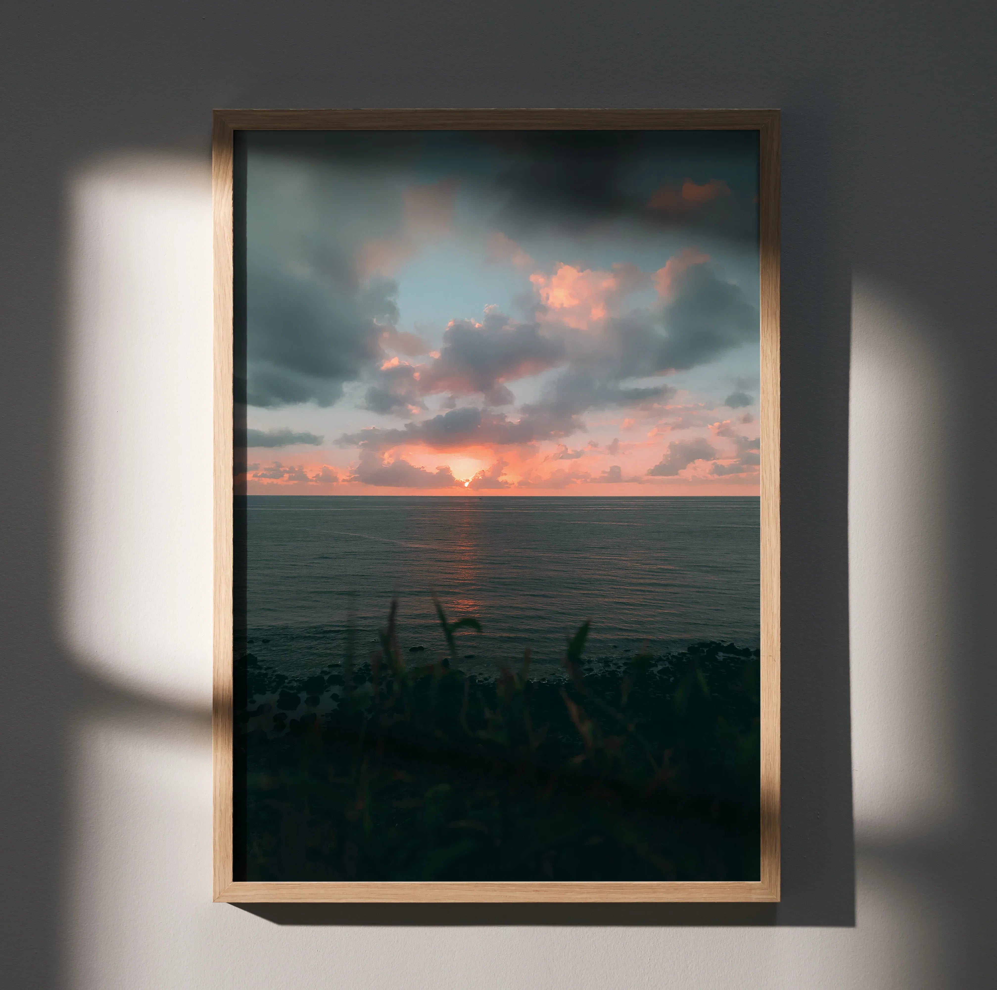 Vertical wall art poster of an ocean sunset beach with dramatic clouds and warm colors.