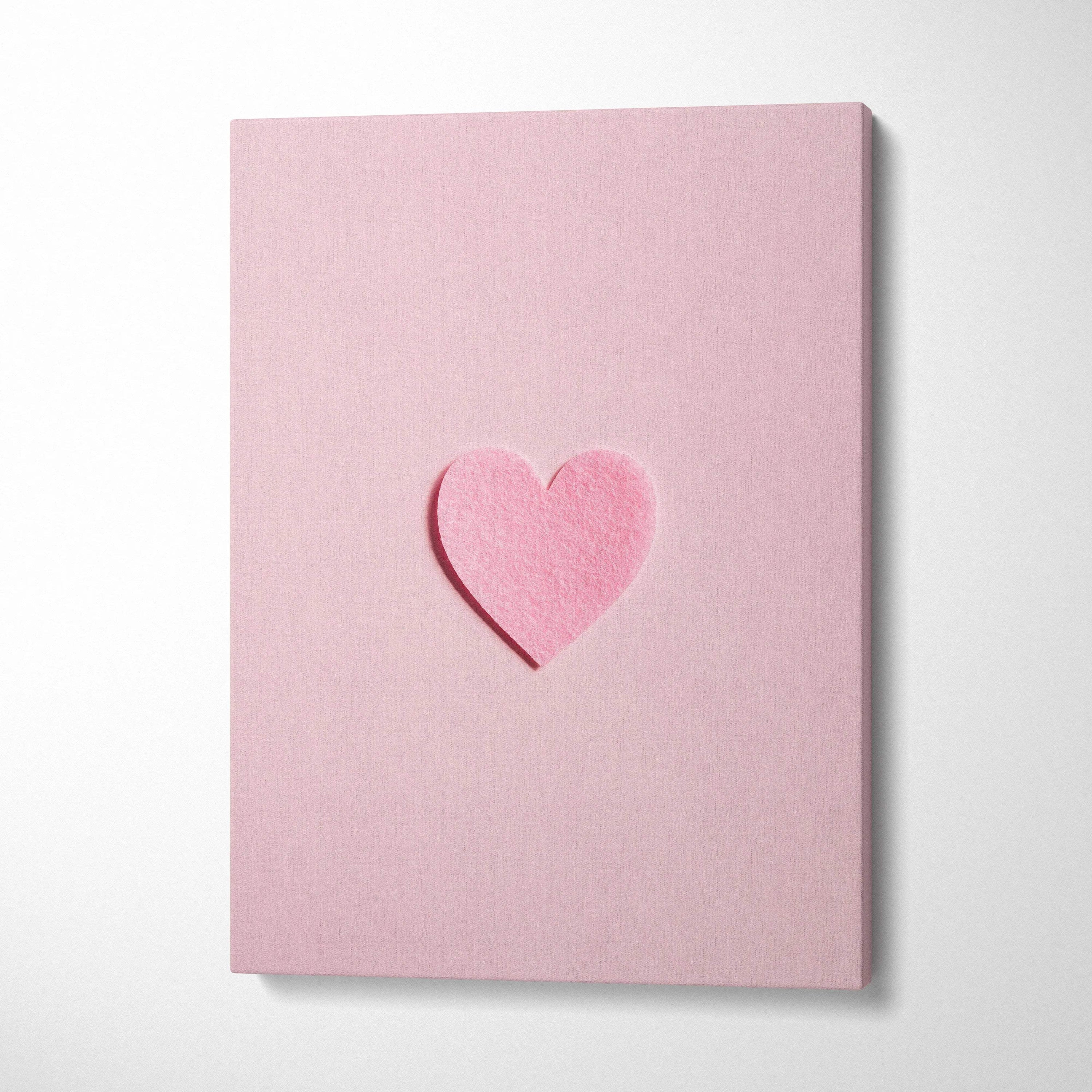 Minimal pink felt heart on pastel pink canvas wall art flat lay