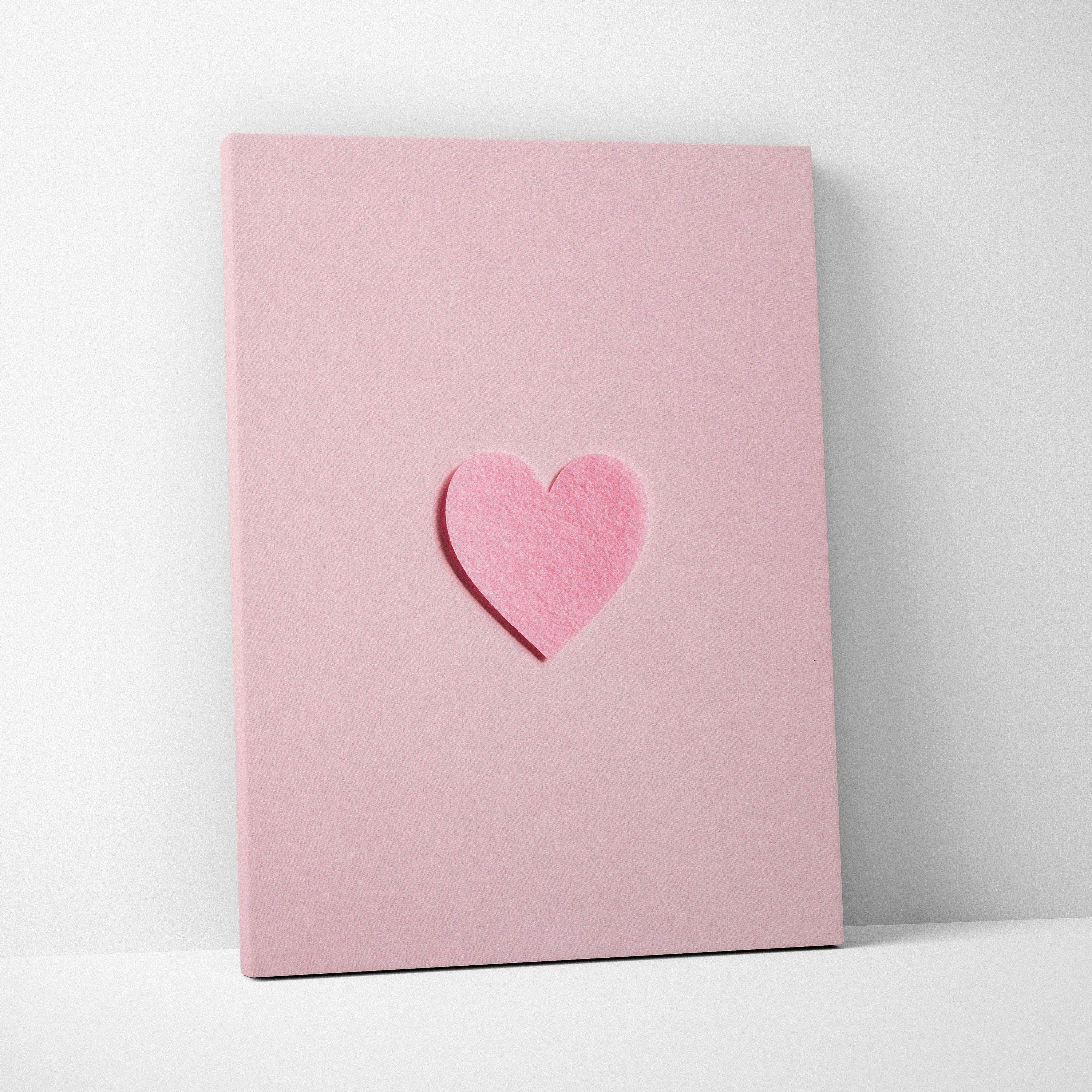 Minimal pink felt heart applique on pastel pink canvas wall art flat lay