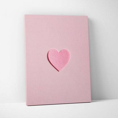 Minimal pink felt heart applique on pastel pink canvas wall art flat lay