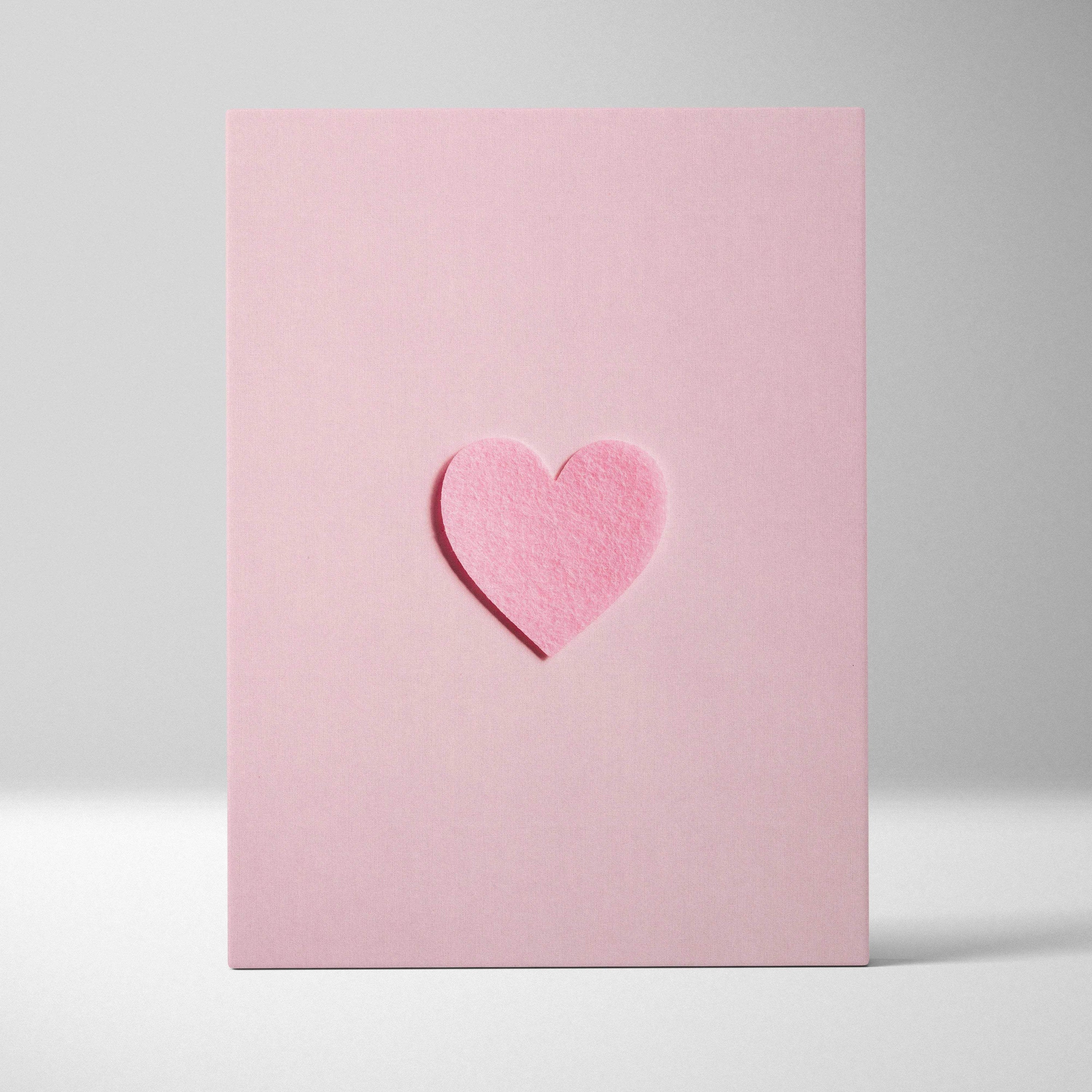 Minimal pink felt heart embossed on pastel pink canvas wall art flat lay