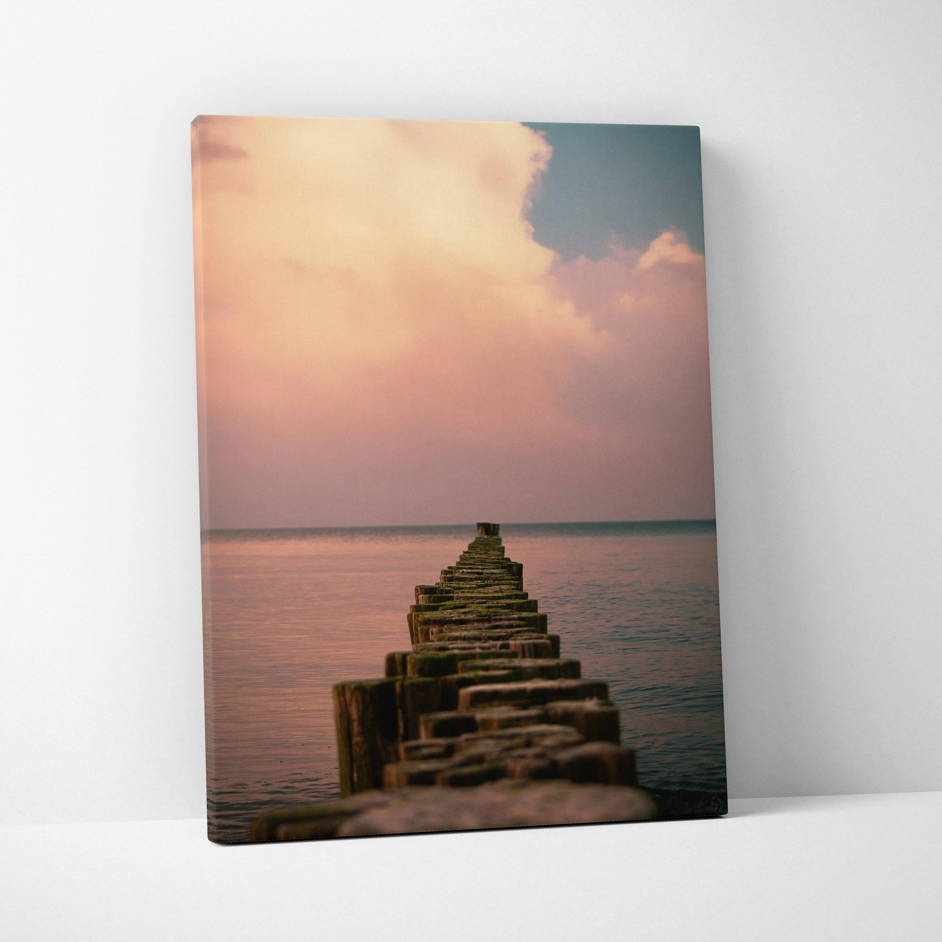 Ocean sunset beach scene on vertical canvas wall art with wooden pier extending into calm water.