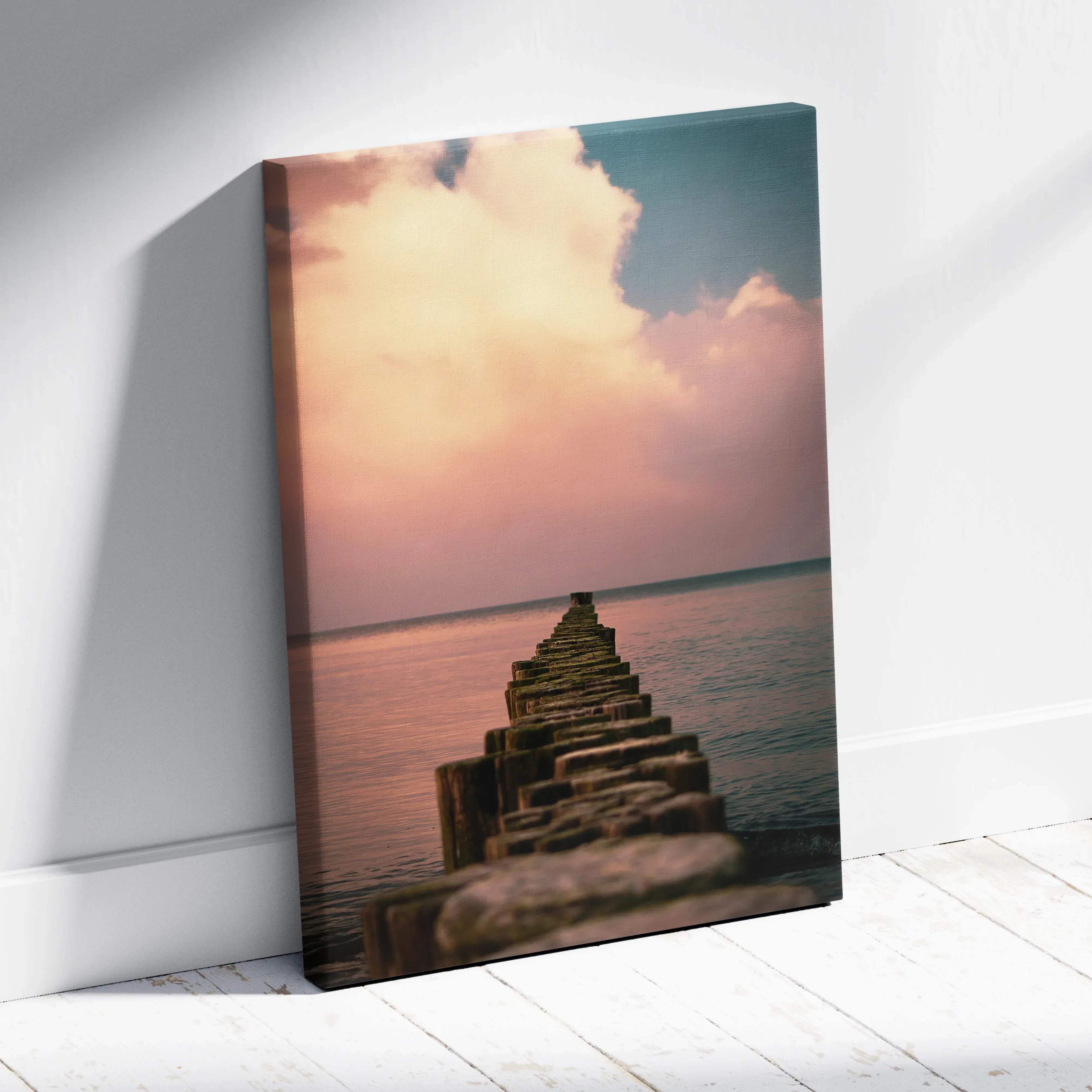 Rectangular canvas wall art print of a weathered wooden pier over calm water with a soft peach sky and serene waves