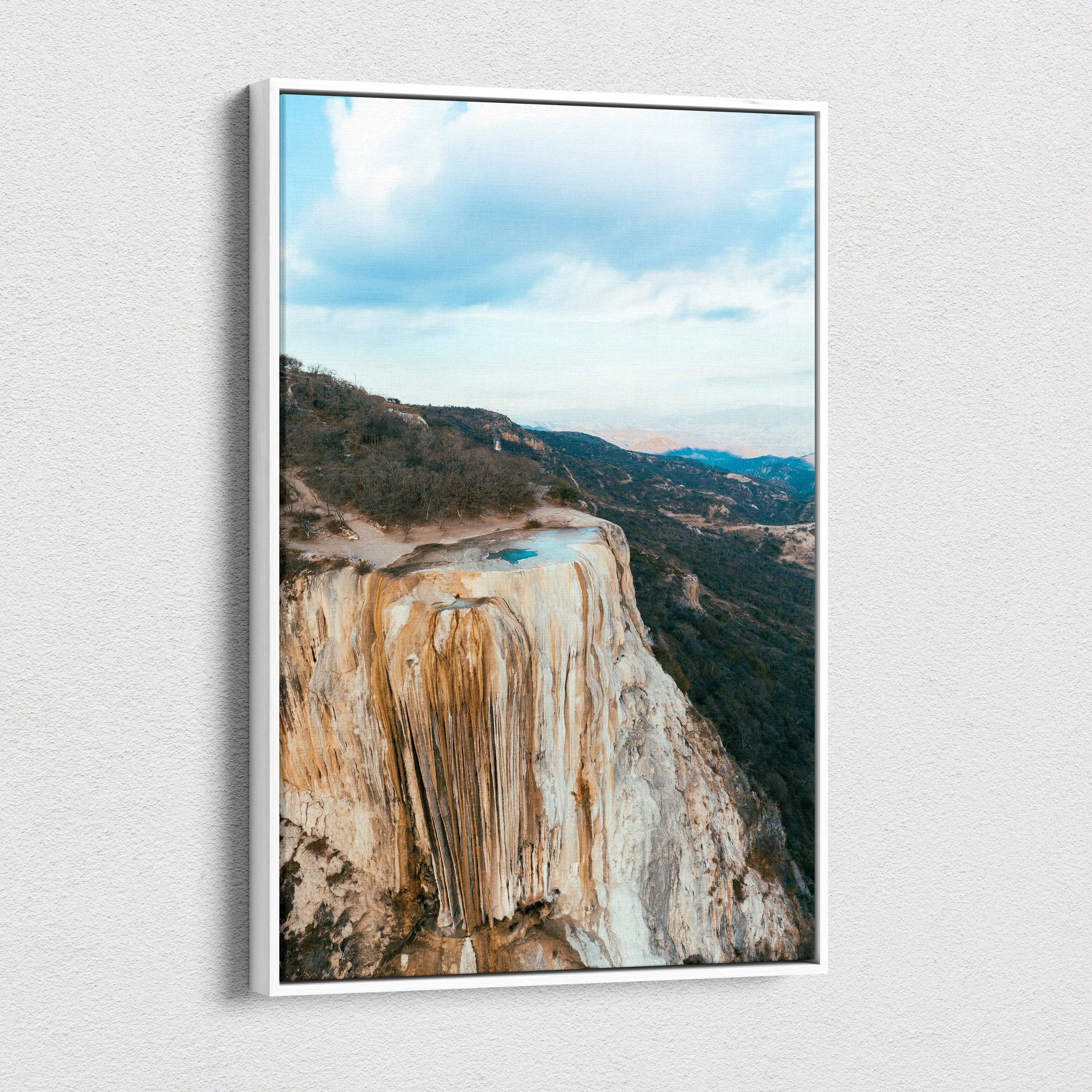 Mountain landscape canvas wall art featuring rocky cliffs and a bright blue sky, vertical orientation.