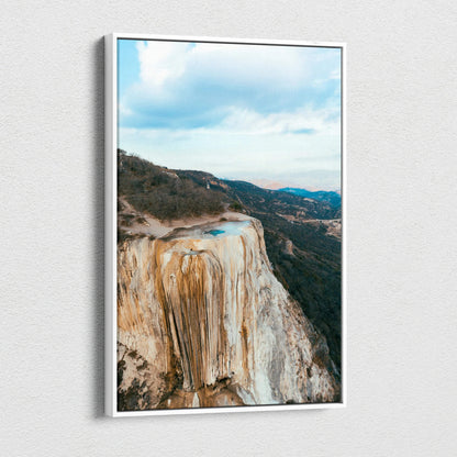 Mountain landscape canvas wall art featuring rocky cliffs and a bright blue sky, vertical orientation.