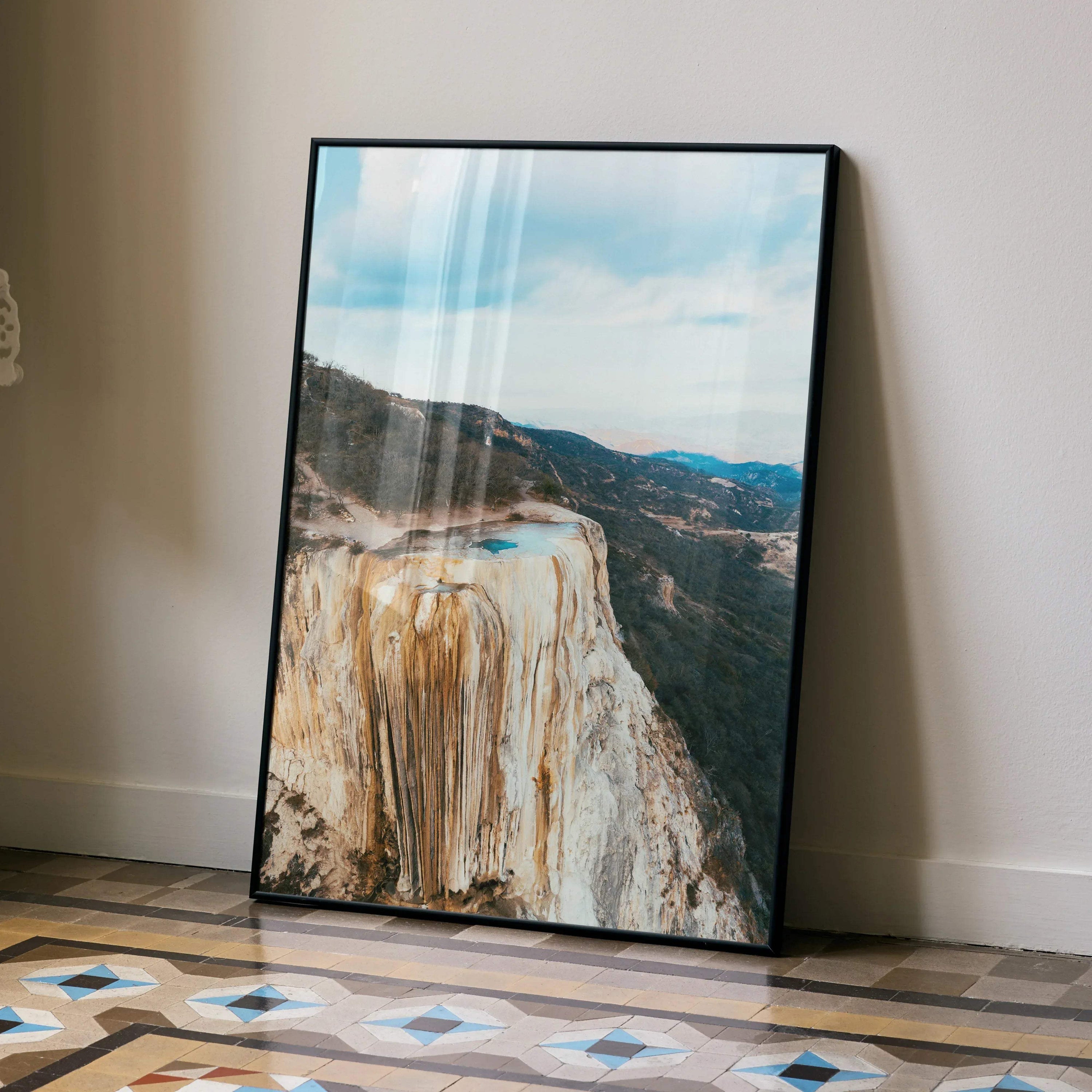 Majestic mountain landscape poster with rocky cliffs and blue sky wall art in black frame.